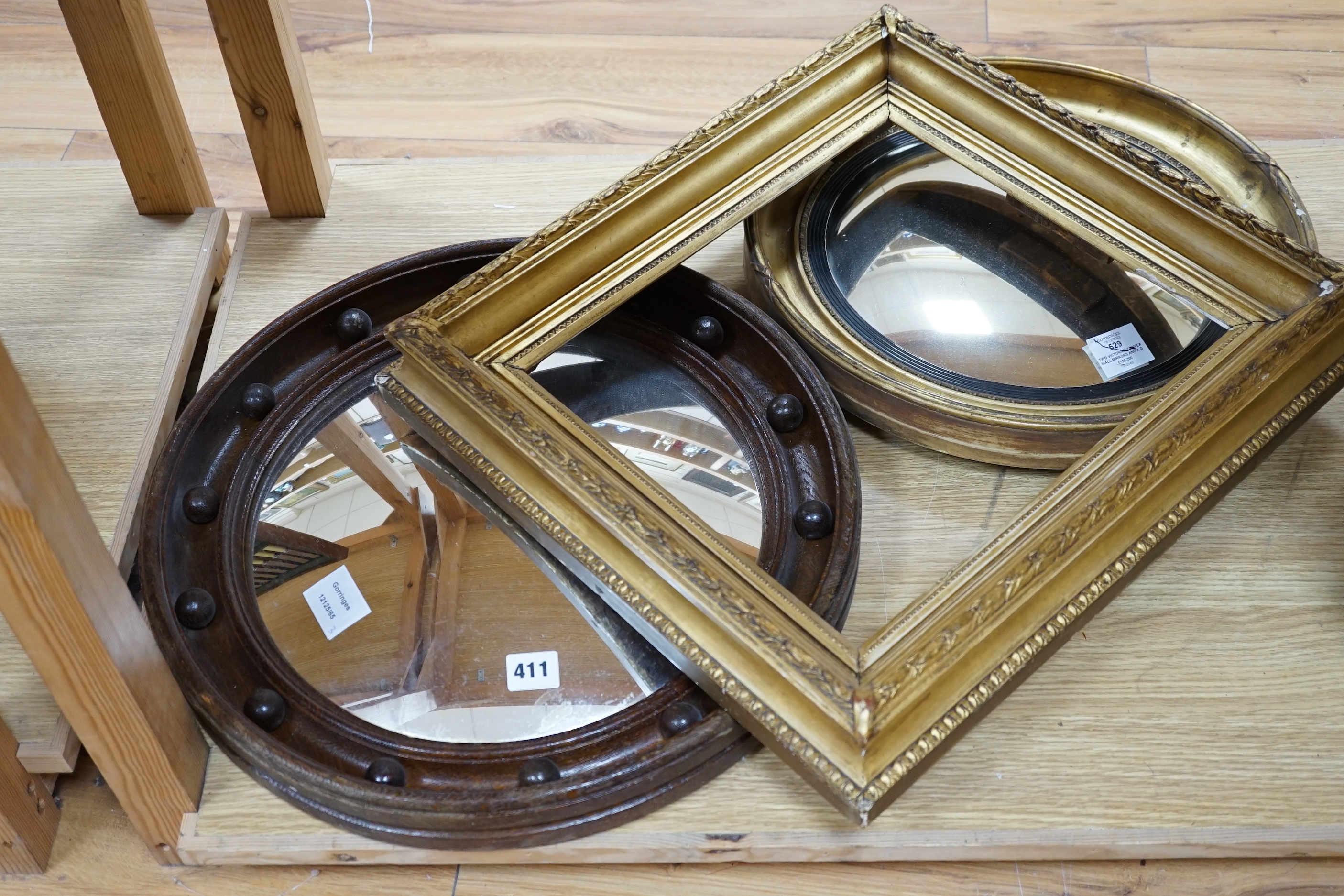 Two Victorian convex wall mirrors and a gilt painted picture frame, largest mirror 46cm diameter